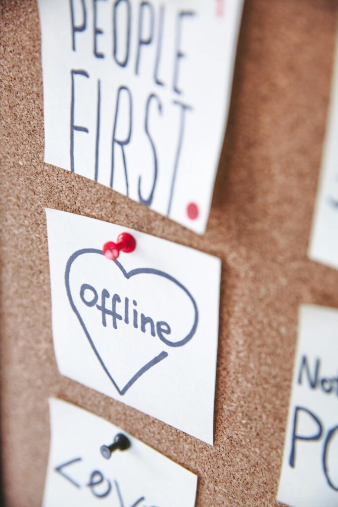 Motivational notes pinned to a bulletin board, encouraging offline focus and prioritizing people.